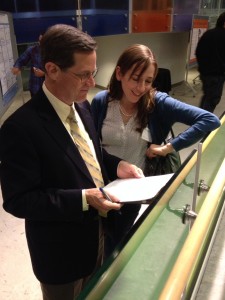 Drs. John Houle and Victoria Claydon judging posters.
